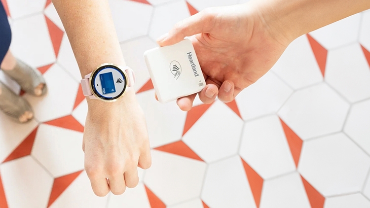 Making a mobile payment using a watch and Heartland hardware.