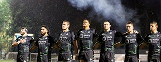 Seawolves team standing together on field.