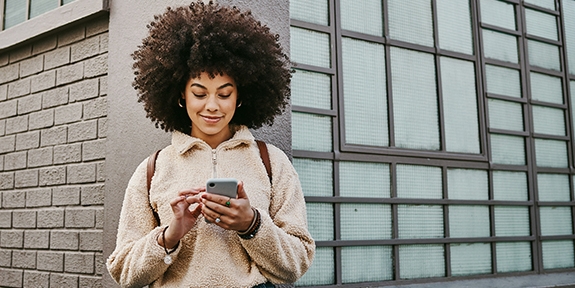 Woman using her cellphone while out in the city