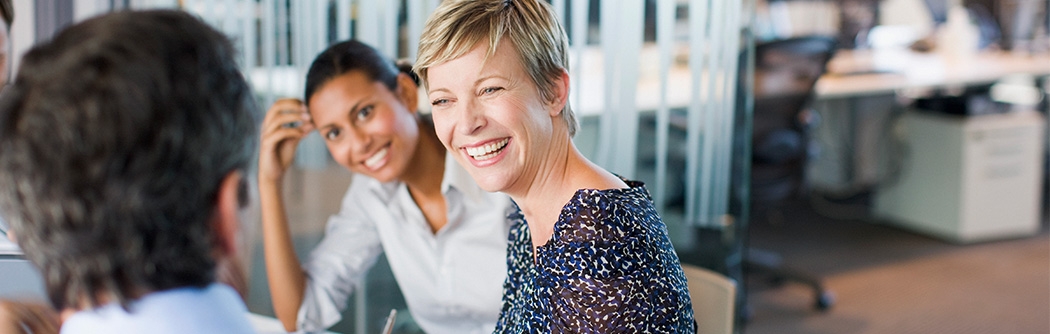 Women smiling in business meeting