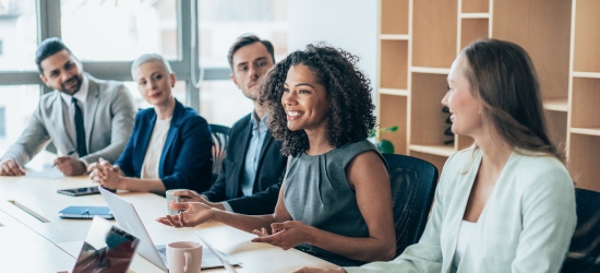 Team of businesspeople sitting together at a meeting in the office.