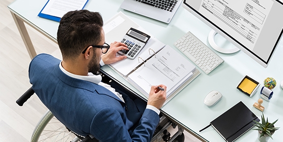 Businessman in a wheelchair at a desk.