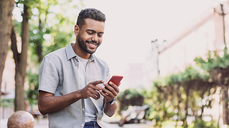 Man using a smartphone outside in a park