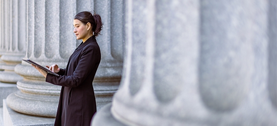 Female lawyer in front of the courthouse.