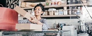 A young business owner packaging products.