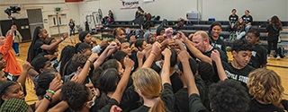 Seattle Storm team high-five at Denali Basketball Clinic.