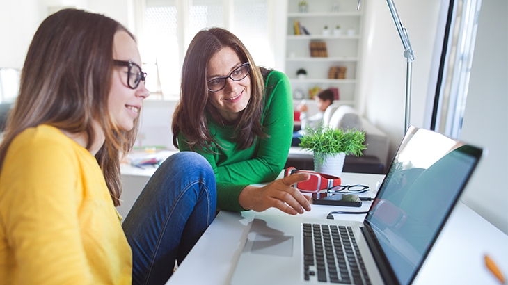 Mother and daughter using a laptop.