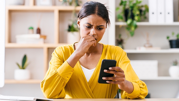 Concerned woman checking her mobile phone.