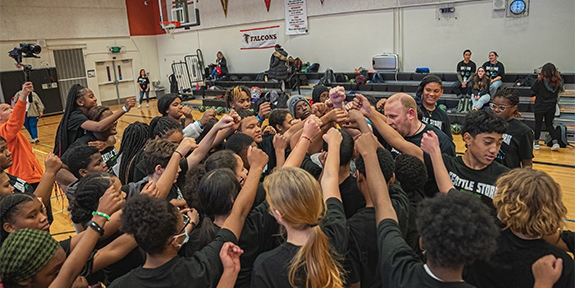 Seattle Storm team high-five at Denali Basketball Clinic.