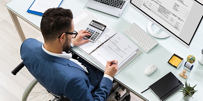 Businessman in a wheelchair at a desk.