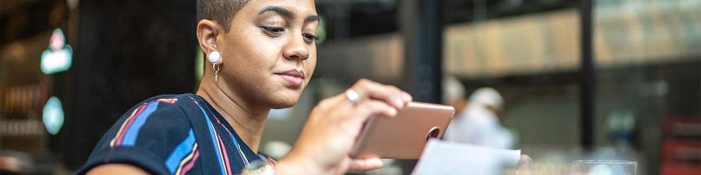 Woman depositing check with a mobile phone.