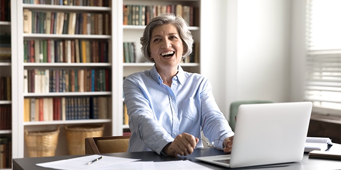 Businesswoman in her office laughing.