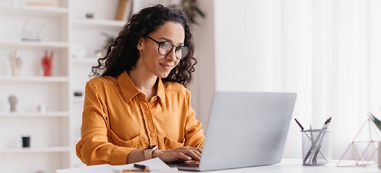 Businesswoman sitting in an office with a laptop