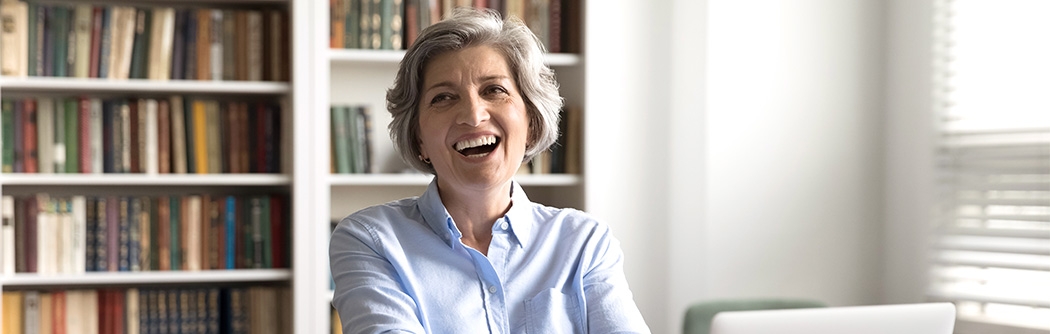 Businesswoman in her office laughing.