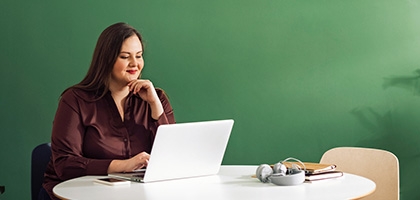 Businesswoman working on laptop at a table