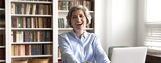 Businesswoman in her office laughing.