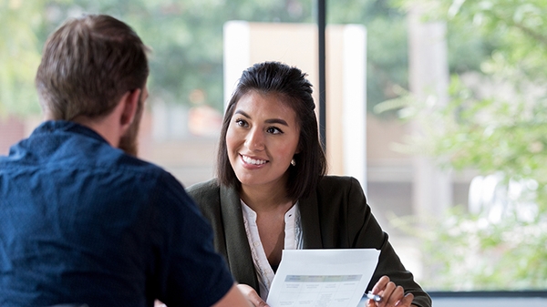 Banker talking with client in office