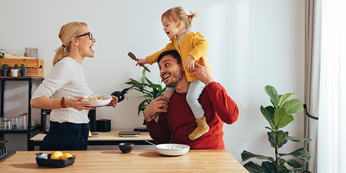 Family playing while cooking in the kitchen.