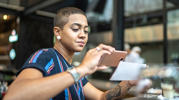 Woman depositing check with a mobile phone