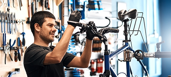 Man working on a bike in a bicycle repair shop