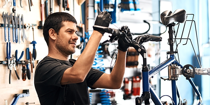 Man working on a bike in a bicycle repair shop