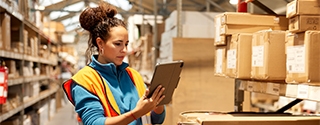 Woman using a tablet in a warehouse.