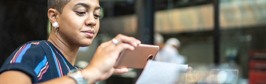 Woman depositing check with a mobile phone.