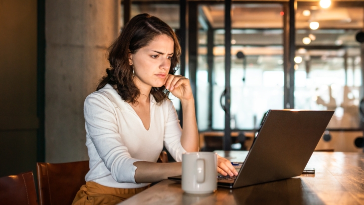 Woman having problems with her laptop with a confused and frustrated look