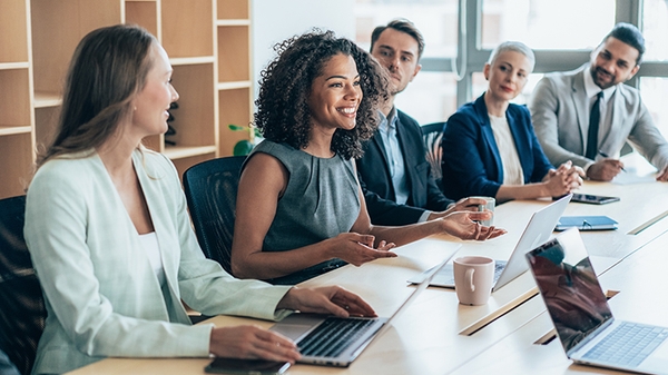 Team of businesspeople sitting together at a meeting in the office.
