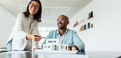 Colleagues looking at an architectural model.
