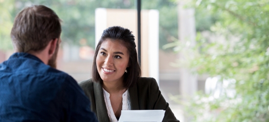 Banker talking with client in office