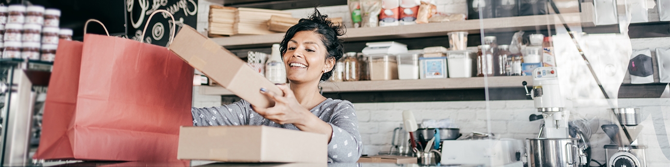 A young business owner packaging products.