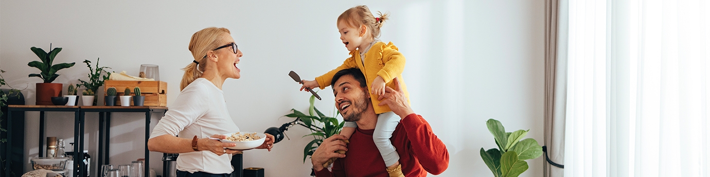 Family playing while cooking in the kitchen.