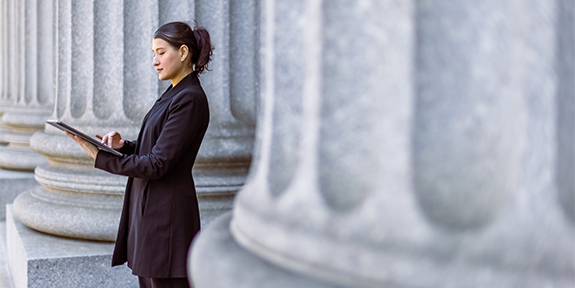 Female lawyer in front of the courthouse.