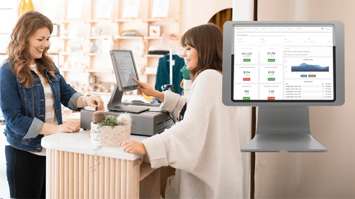Heartland retail checkout with mobile phone, card reader, and credit card.