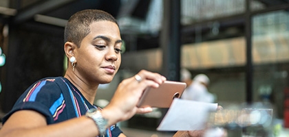 Woman depositing check with a mobile phone.