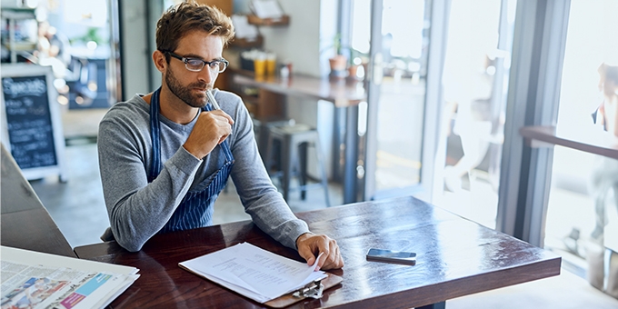 Business owner doing accounting in his shop.