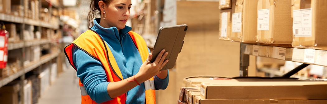 Woman using a tablet in a warehouse.