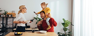 Family playing while cooking in the kitchen.