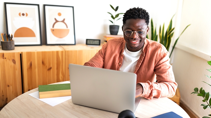 Young man using laptop at home.