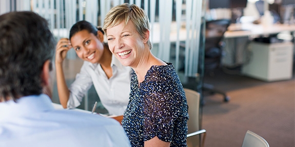 Women smiling in business meeting