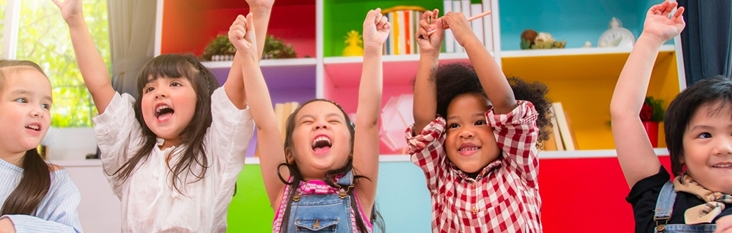 Happy schoolkids celebrating