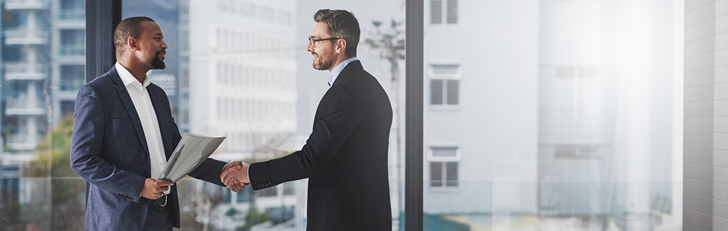 Two businessmen shaking hands at work.