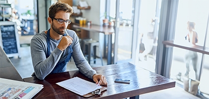 Business owner doing accounting in his shop.