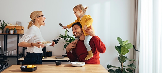 Family playing while cooking in the kitchen