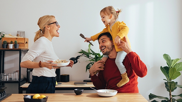 Family playing while cooking in the kitchen.