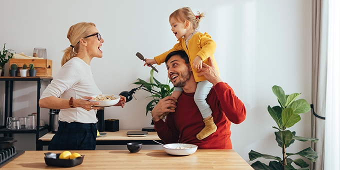 Family playing while cooking in the kitchen.