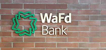 WaFd Bank sign on a brick wall.
