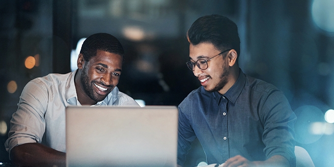 Two business men working on laptop in the office