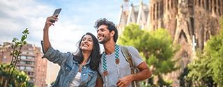 Couple taking picture vacation photo in Barcelona